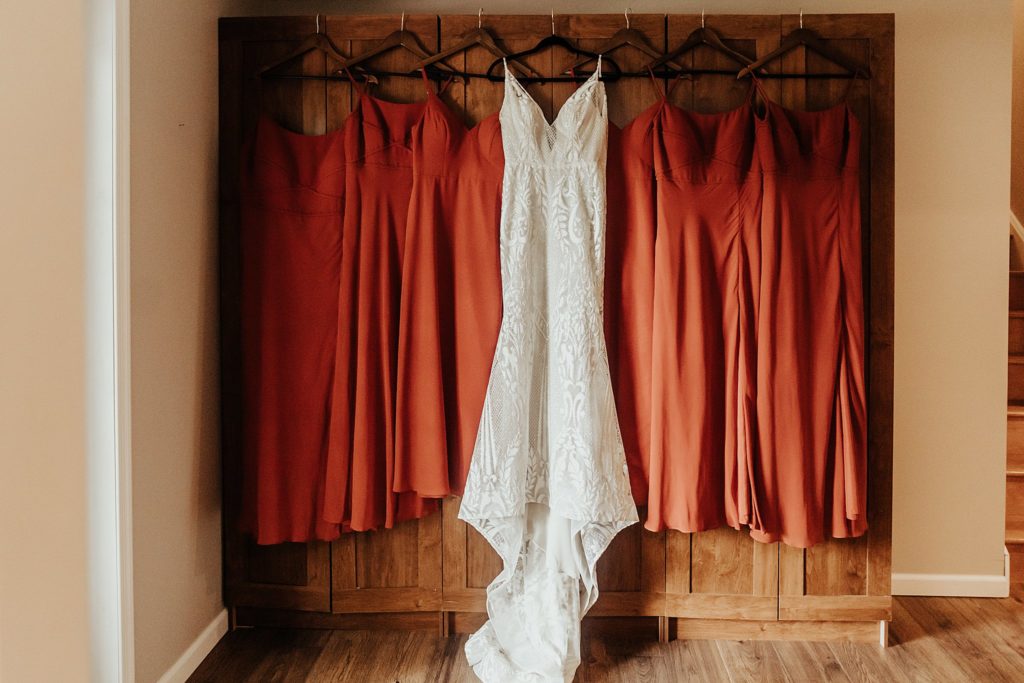Terracotta bridesmaids dresses hanging up at Philadelphia West Chester KOA campground wedding