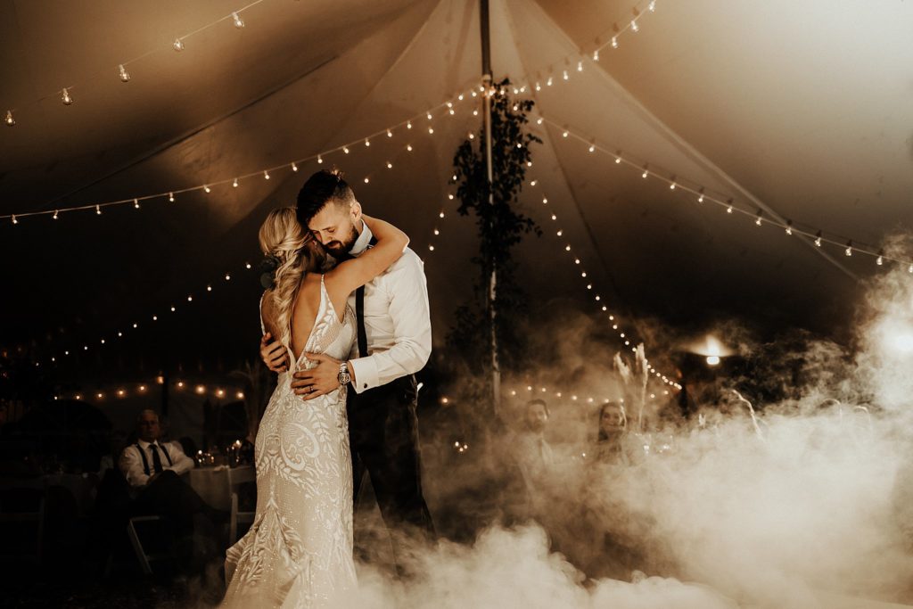 a smoke machine is used during a bride's first dance inside a tent at her philadelphia campground wedding alongside the brandywine river at the philadelphia KOA 