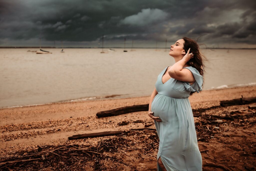 Stormy Beach Expecting Mother in Blue Dress