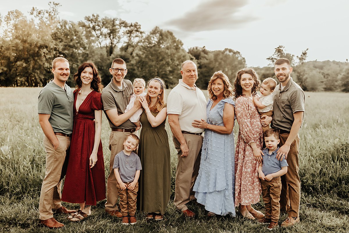Family in West Chester during an extended family photoshoot with grandparents and grandchildren as well as adult children. Colors for family photos include blues, neutrals, warm tones, greens, khakis.